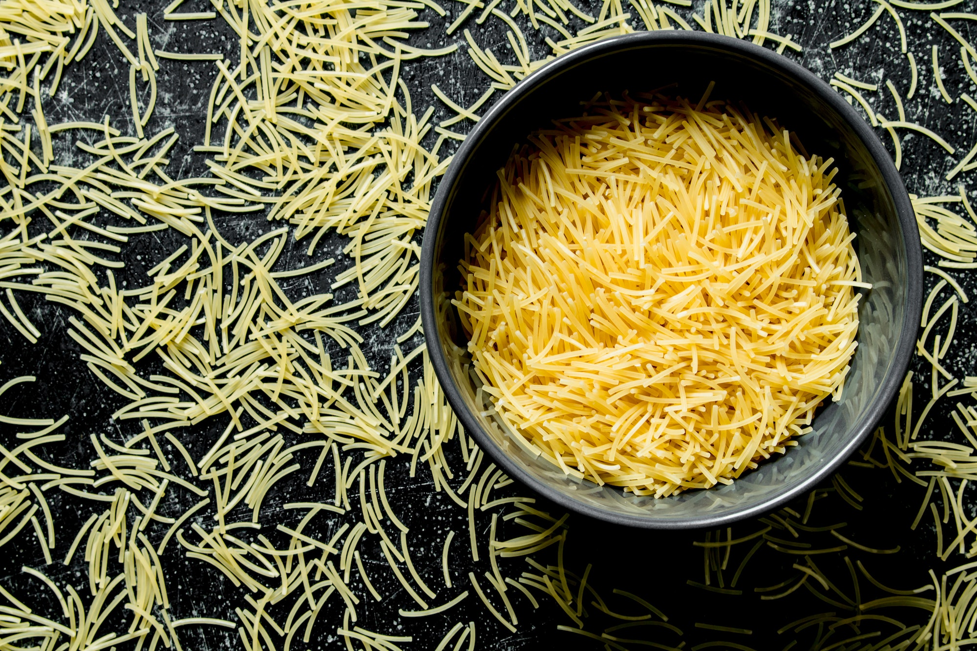 Pasta background. Vermicelli dry pasta in a bowl.